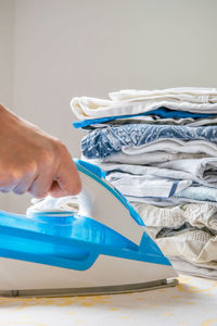 Close-up of woman ironing clothes