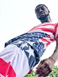 Low angle view of man against flag