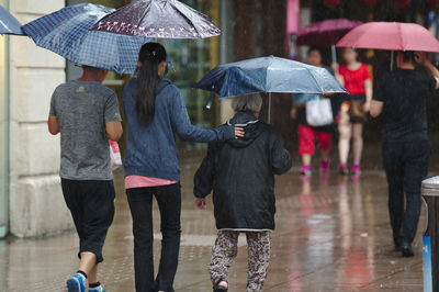 Group of people walking in wet rainy season
