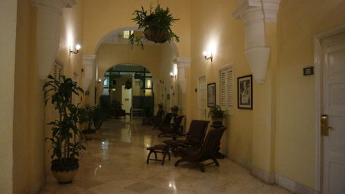 Empty chairs and tables in illuminated building