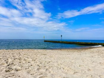 Scenic view of beach against blue sky