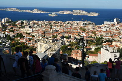 High angle view of buildings by sea against sky