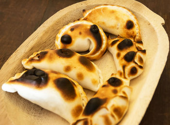 Close-up view of breads on wooden plate