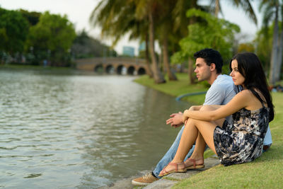 Young couple sitting in water