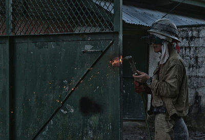 Young woman holding umbrella on floor