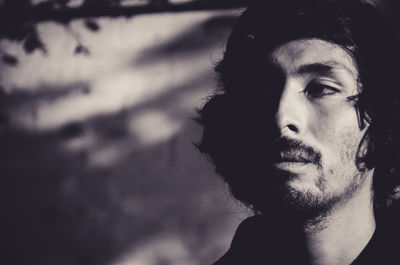 Close-up portrait of young man looking away