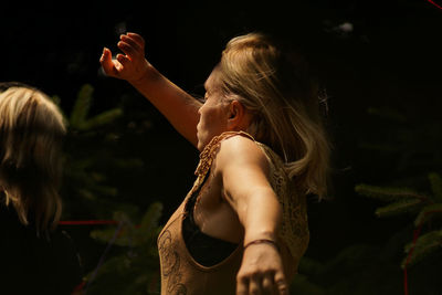 Rear view of women standing against blurred background