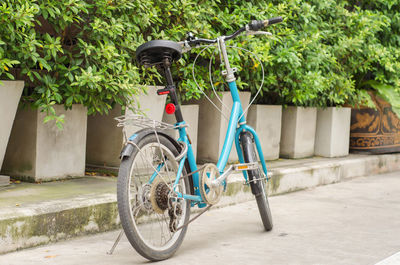 Bicycle parked on footpath in park