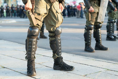 Low section of army soldiers standing on street