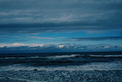 Scenic view of sea against storm clouds