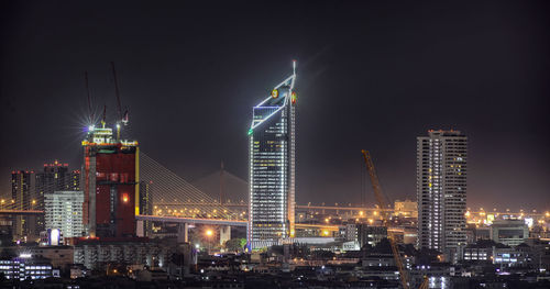 Illuminated buildings in city at night