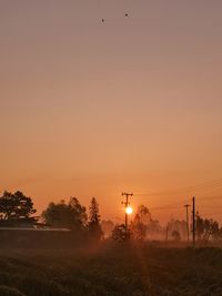 Scenic view of field against sky during sunset