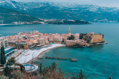 High angle view of townscape by sea