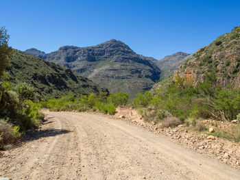 Scenic view of mountains against clear blue sky