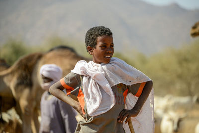 Portrait of boy standing outdoors