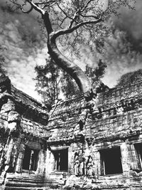 Low angle view of building against cloudy sky