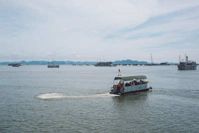 Boat sailing in sea against sky