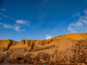 Panoramic view of desert against blue sky