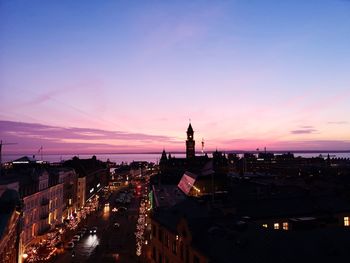 High angle view of buildings in city during sunset