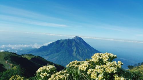 Scenic view of mountains against blue sky