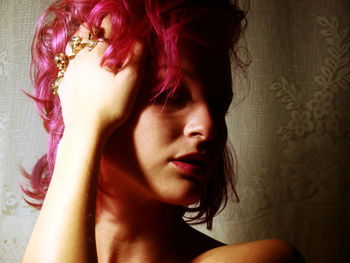 Close-up of young woman with dyed pink hair