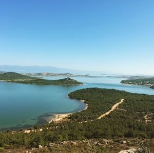 Scenic view of lake against clear blue sky