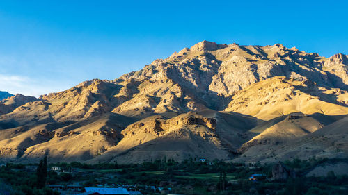 Scenic view of snowcapped mountains against blue sky