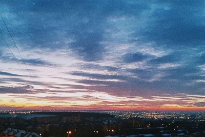 Aerial view of cityscape against sky during sunset