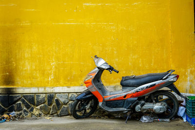 Side view of motor scooter on wall