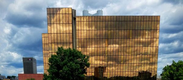 Low angle view of building against cloudy sky