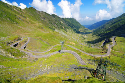 Winding country road leading towards mountains