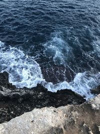 High angle view of rocks on sea shore