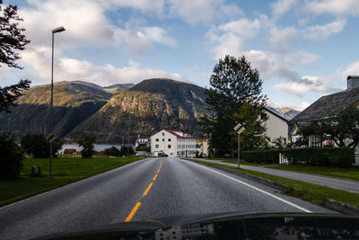 Road by mountain against sky