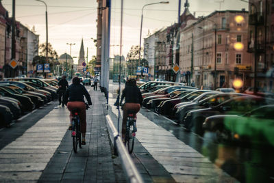 Reflection of person cycling on street in city