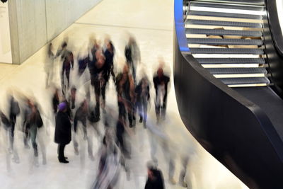 High angle view of people walking on railroad station