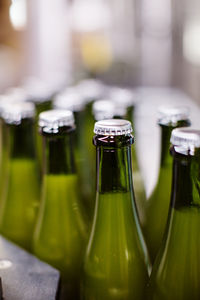 Close-up of lids on beer bottles at brewery