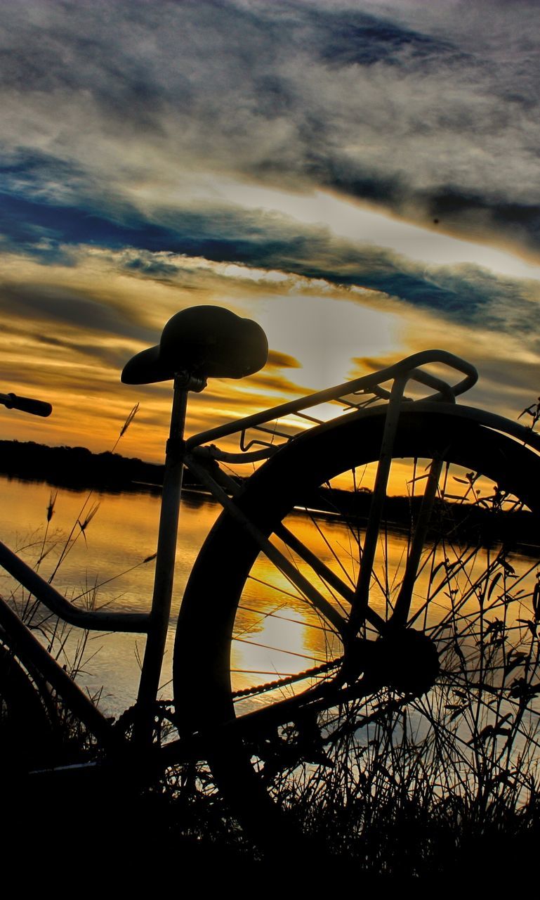 SILHOUETTE OF BICYCLE AGAINST CLOUDY SKY
