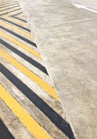 High angle view of yellow crossing sign on road