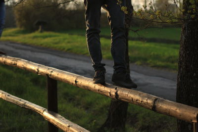 Low section of man standing on grass