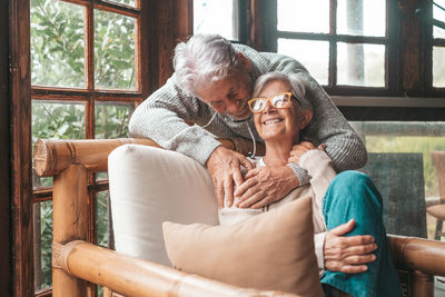 Low angle view of woman sitting on sofa at home