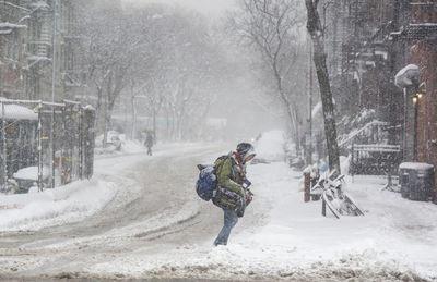 Rear view of person on snow covered street