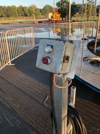 Close-up of railing by road in city