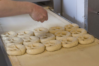 Cropped hand of man preparing food in kitchen