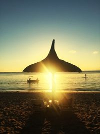 Scenic view of beach against sky during sunset