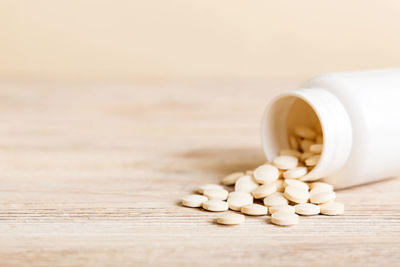 Pills spilling from bottle on table