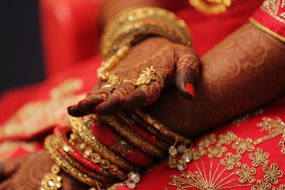 Midsection of bride wearing bangles