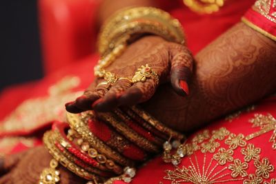 Close-up of woman hand holding red christmas lights