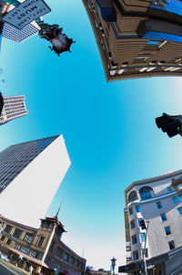 Low angle view of buildings against blue sky