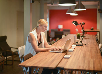 Woman sitting on chair at table