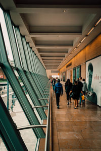 Rear view of people walking in subway station